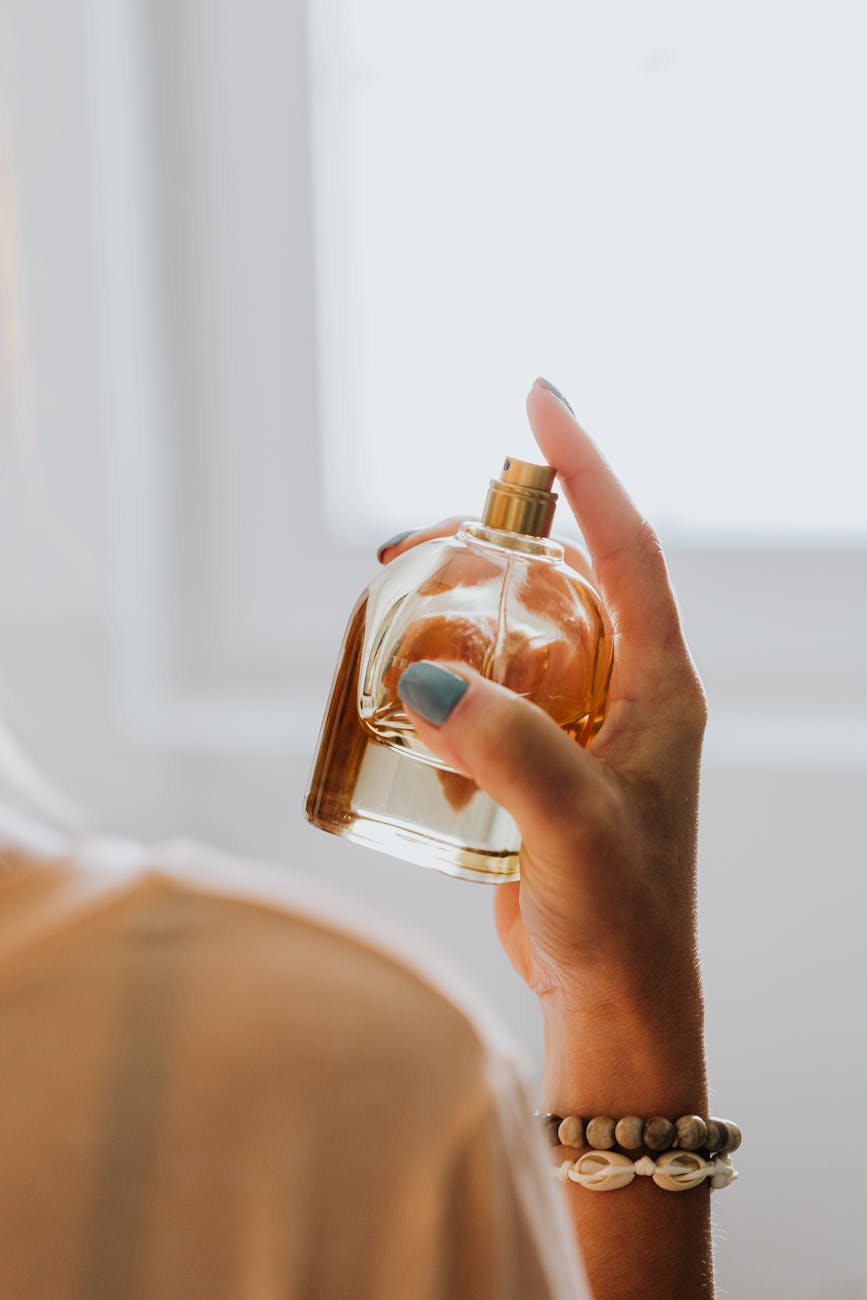 woman spraying perfume
