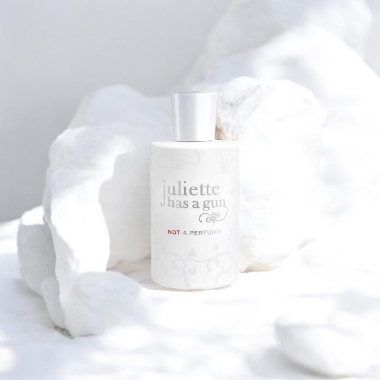 Juliette Has a Gun Not a Perfume bottle surrounded by white rocks