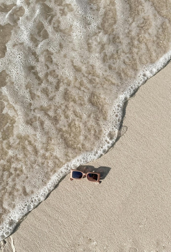 sunglasses on sea shore