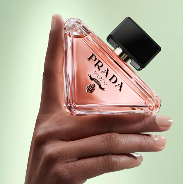 hand holding prada paradoxe eau de parfum bottle