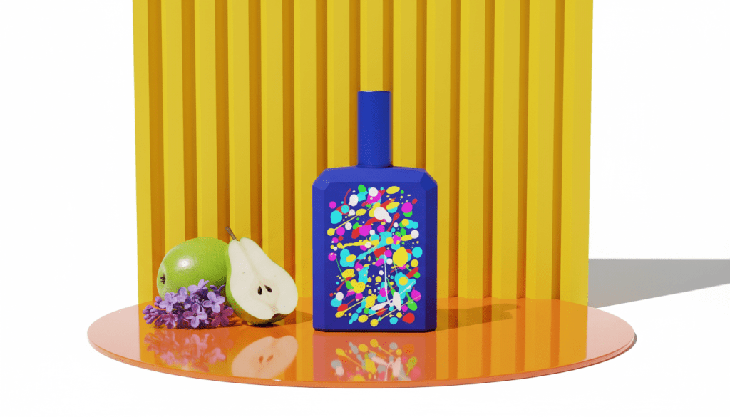 A bright blue Histoires de Parfums 1.2 bottle with multi-colored paint splatters on an orange platform with fresh pear and lilac.
